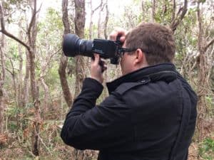 Alex taking a photo of something up a tree